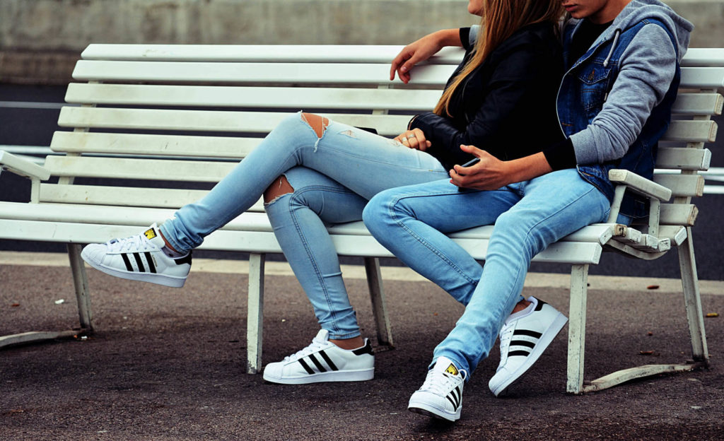 couple arguing on a park bench