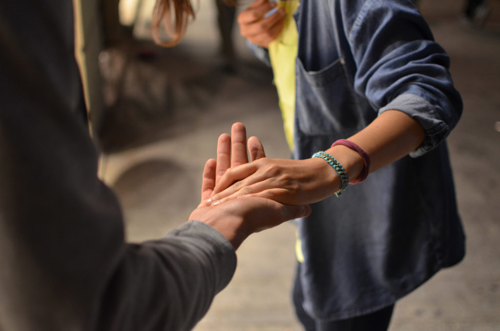 A photo of a couple holding hand through an arguement