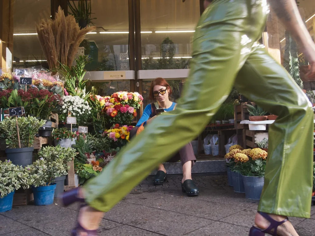 woman walks in front of the camera in a hurry. she doesnt waste time. she is dating up
