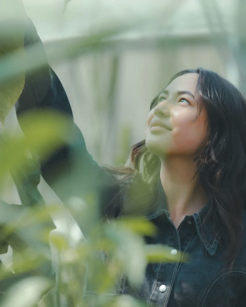 happy woman tending to her self-love and self-acceptance journey