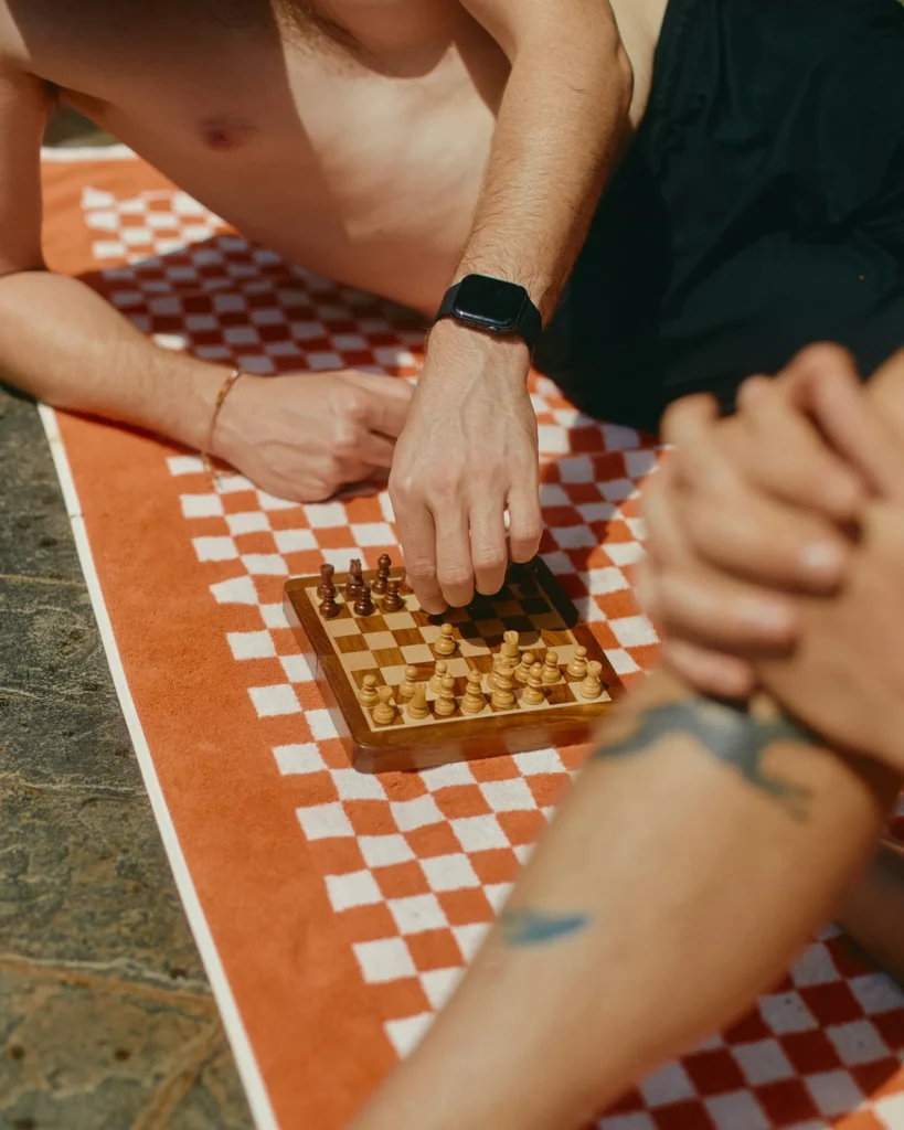 8 Green Flags Every Woman Should Look For in "High Value" Dating. 1 man and woman playing chess, wondering if this is a high value relationship