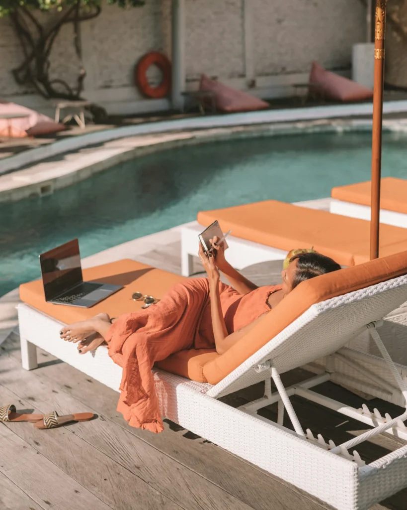 Woman reading book while sunbathing as part of self-love and self-care routine