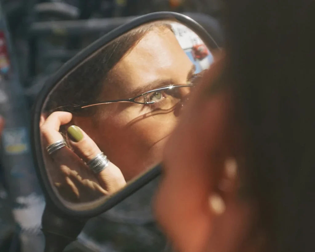 woman check herself in the mirror before dating up